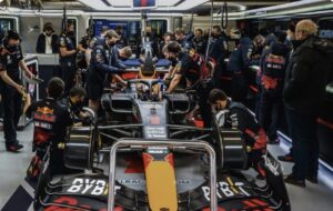 Formula One pit crew working on a race car, illustrating executive AI fluency